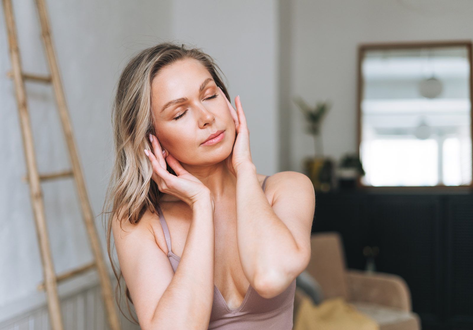 Serene woman enjoying her skincare routine indoors